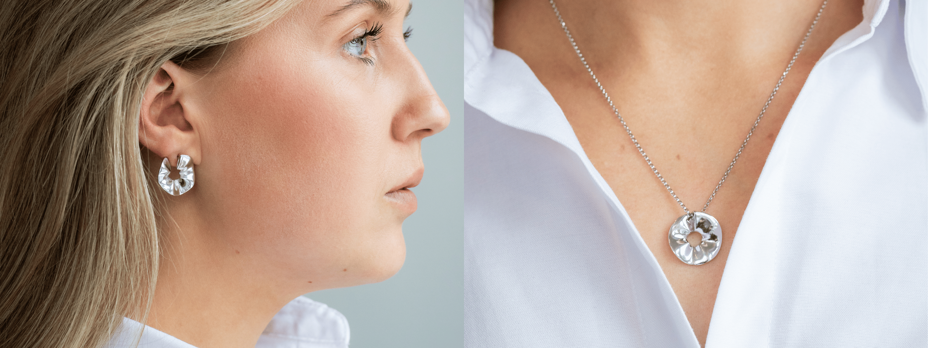 Kvinna i vit skjorta med silverörhängen och silverhalsband